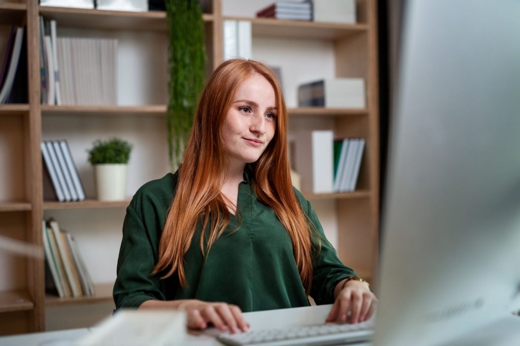 federal programs director working at laptop